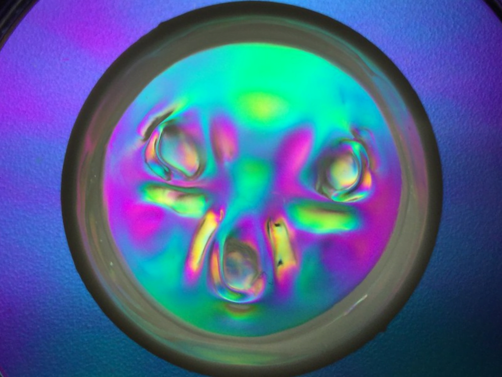 Frozen cymatic waves under cross polarized light. Frozen cymatic waves under cross polarized light.