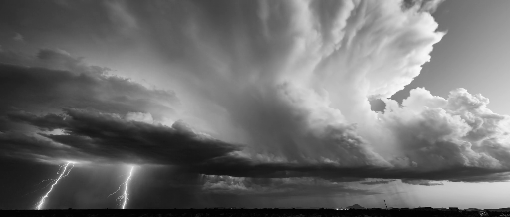 Lightning flashes beneath storm clouds. Lightning flashes beneath storm clouds.
