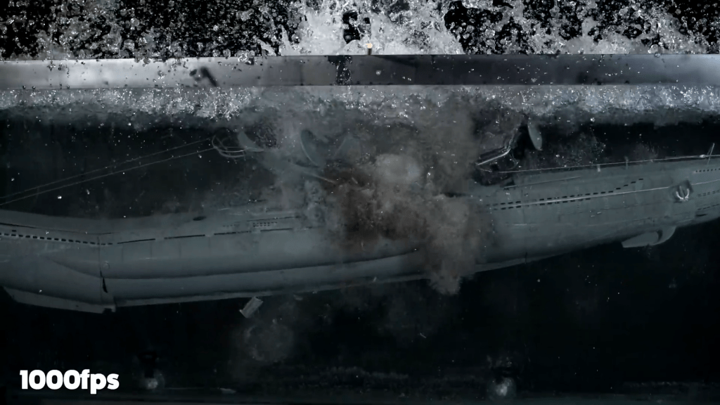 Water erupts on the surface as the submarine model's inner balloon gives. Water erupts on the surface as the submarine model's inner balloon gives.