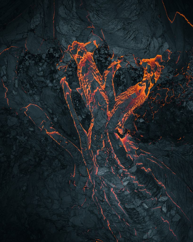 Fingers of lava glow against the black. Fingers of lava glow against the black.