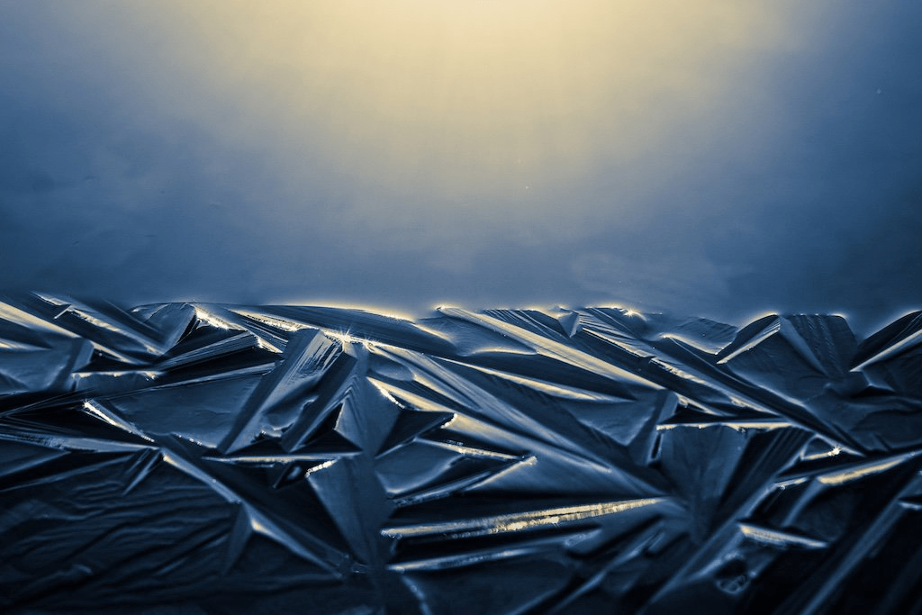 Dawn's first light reveals the earliest hints of winter ice at the edge of this Vermont pond.