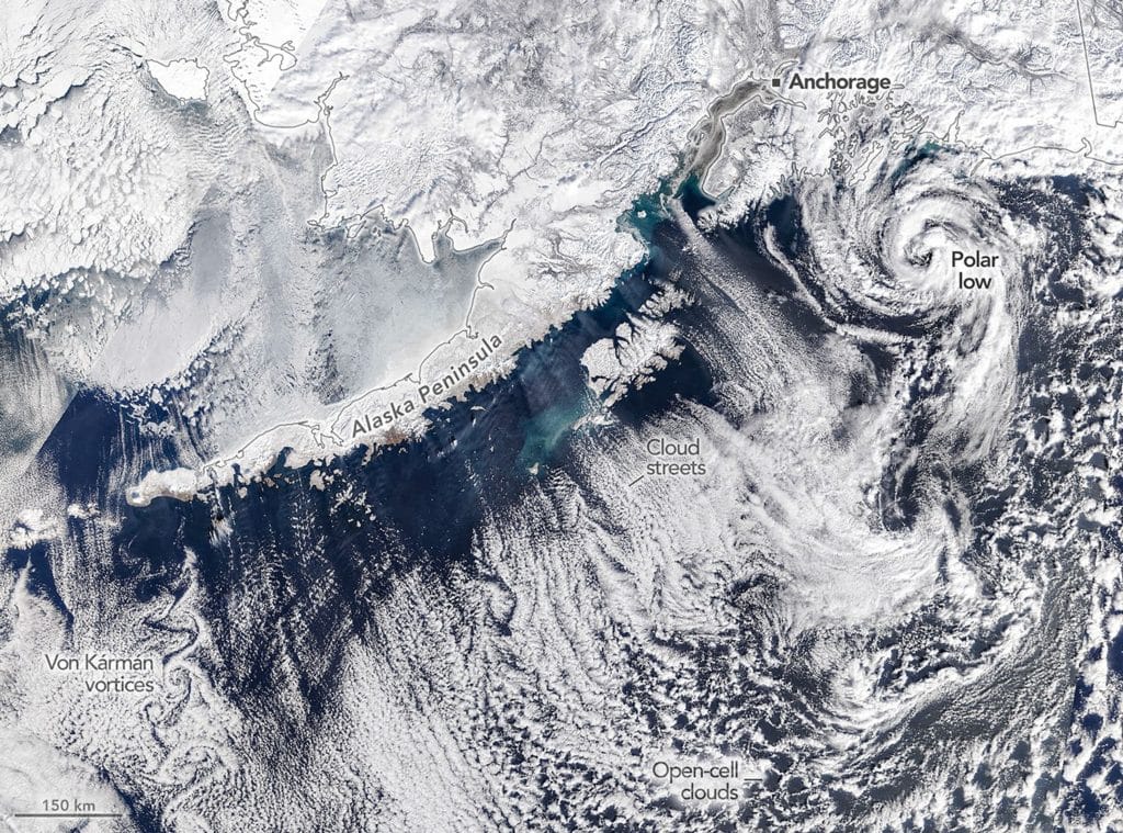 A trio of atmospheric phenomena appear in this satellite image off Alaska: a polar low, cloud streets, and a von Karman vortex street.