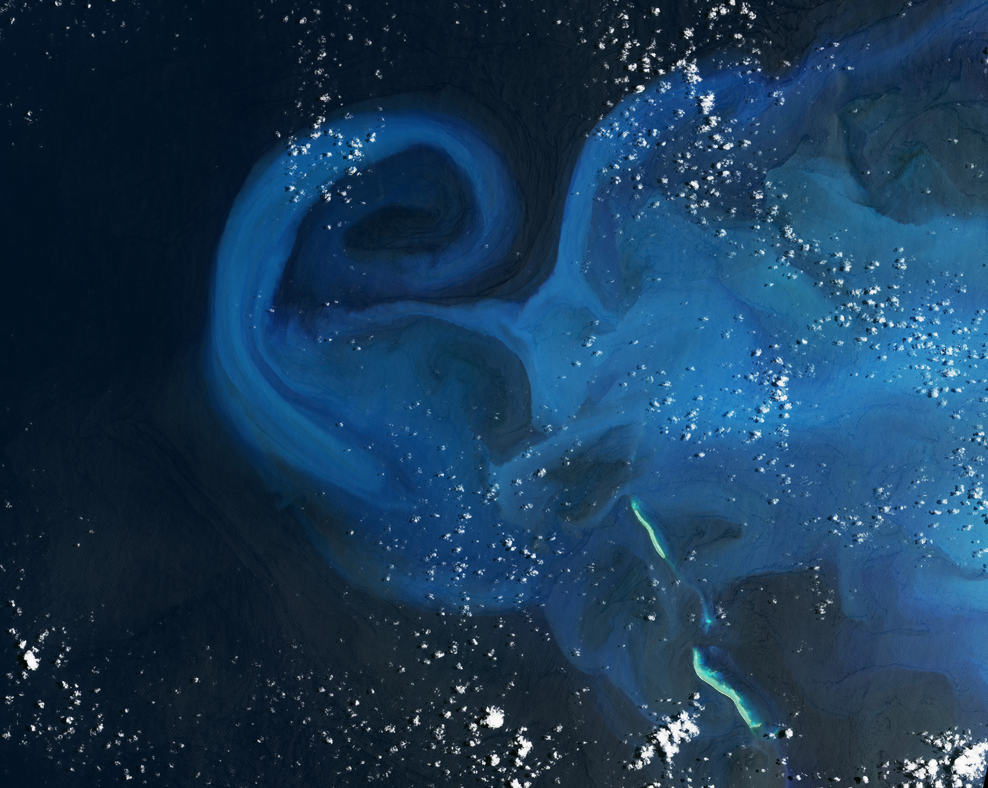 Swirls of carbonate sediment stirred up in the wake of a tropical cyclone.