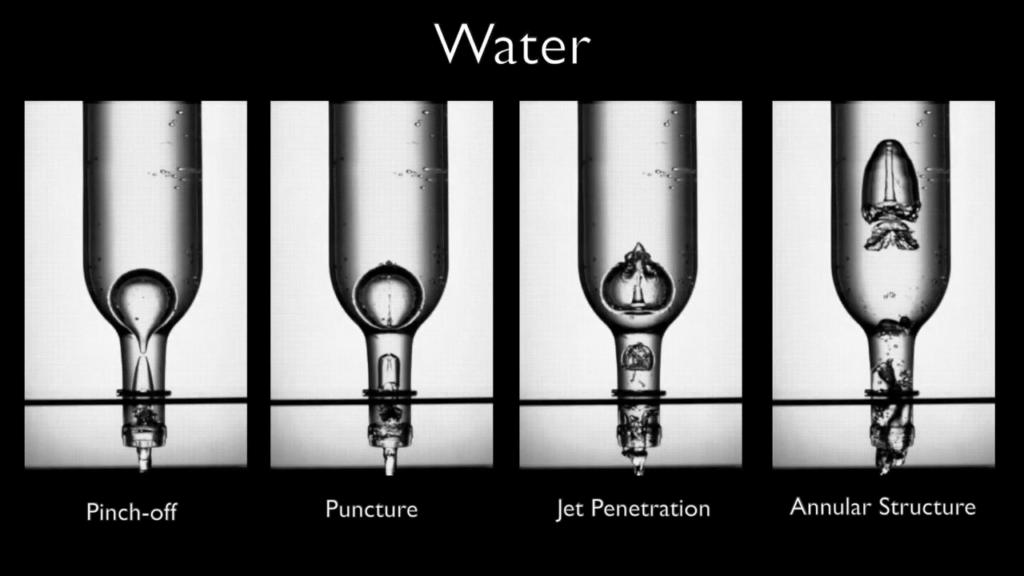 The first bubble in a draining bottle gets punctured by a jet created when the bubble pinches off. The first bubble in a draining bottle gets punctured by a jet created when the bubble pinches off.