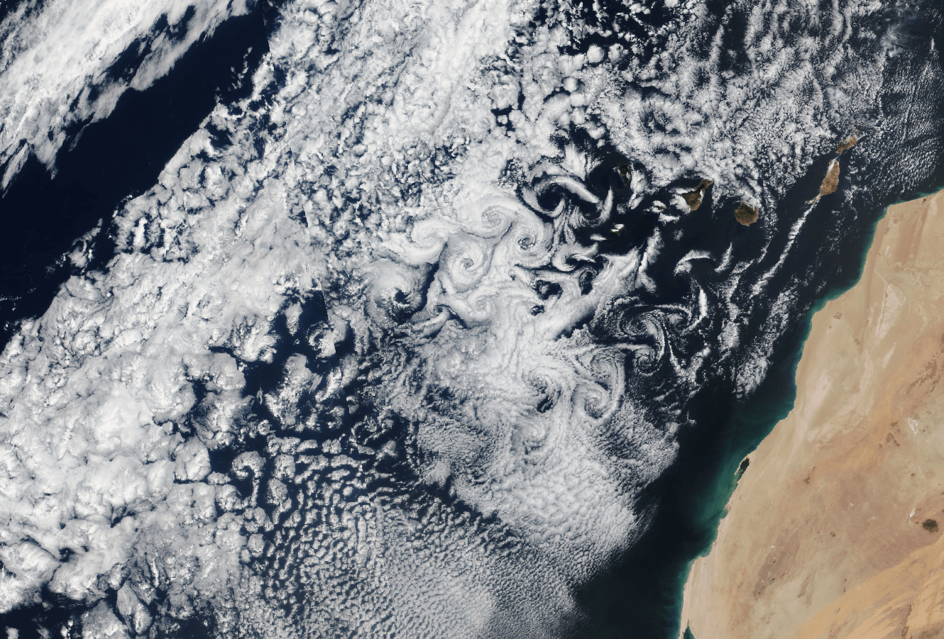 Vortex streets swirl in the clouds downstream of the Canary Islands.