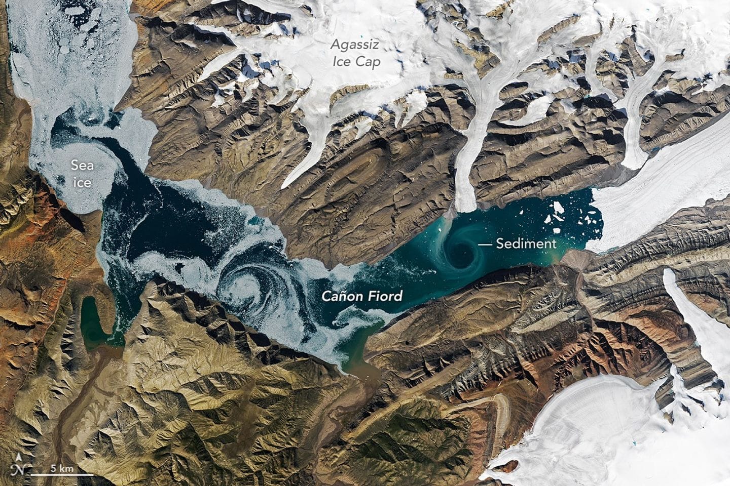 Satellite image of sea ice and sediment swirling in Cañon Fiord.