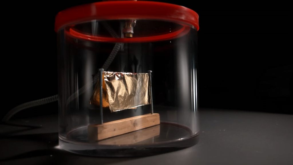 In the vacuum chamber, the gold foil is here one moment...