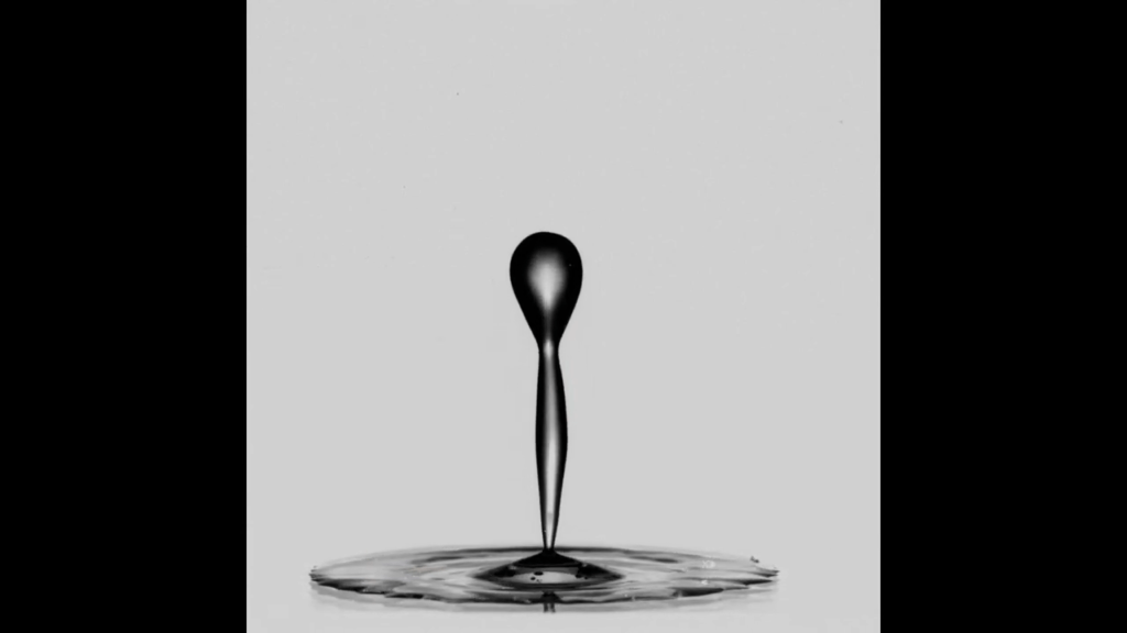 The jet breaks the remainder of the hollow drop and rebounds from the surface. The jet breaks the remainder of the hollow drop and rebounds from the surface.