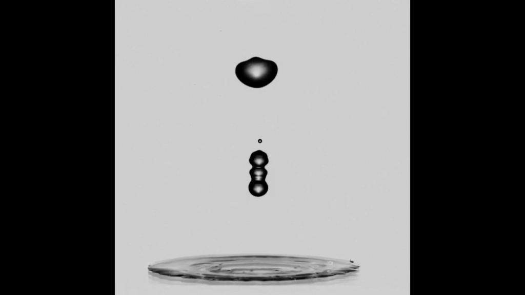 The jet separates into satellite droplets that rise and wobble until gravity pulls them back down. The jet separates into satellite droplets that rise and wobble until gravity pulls them back down.