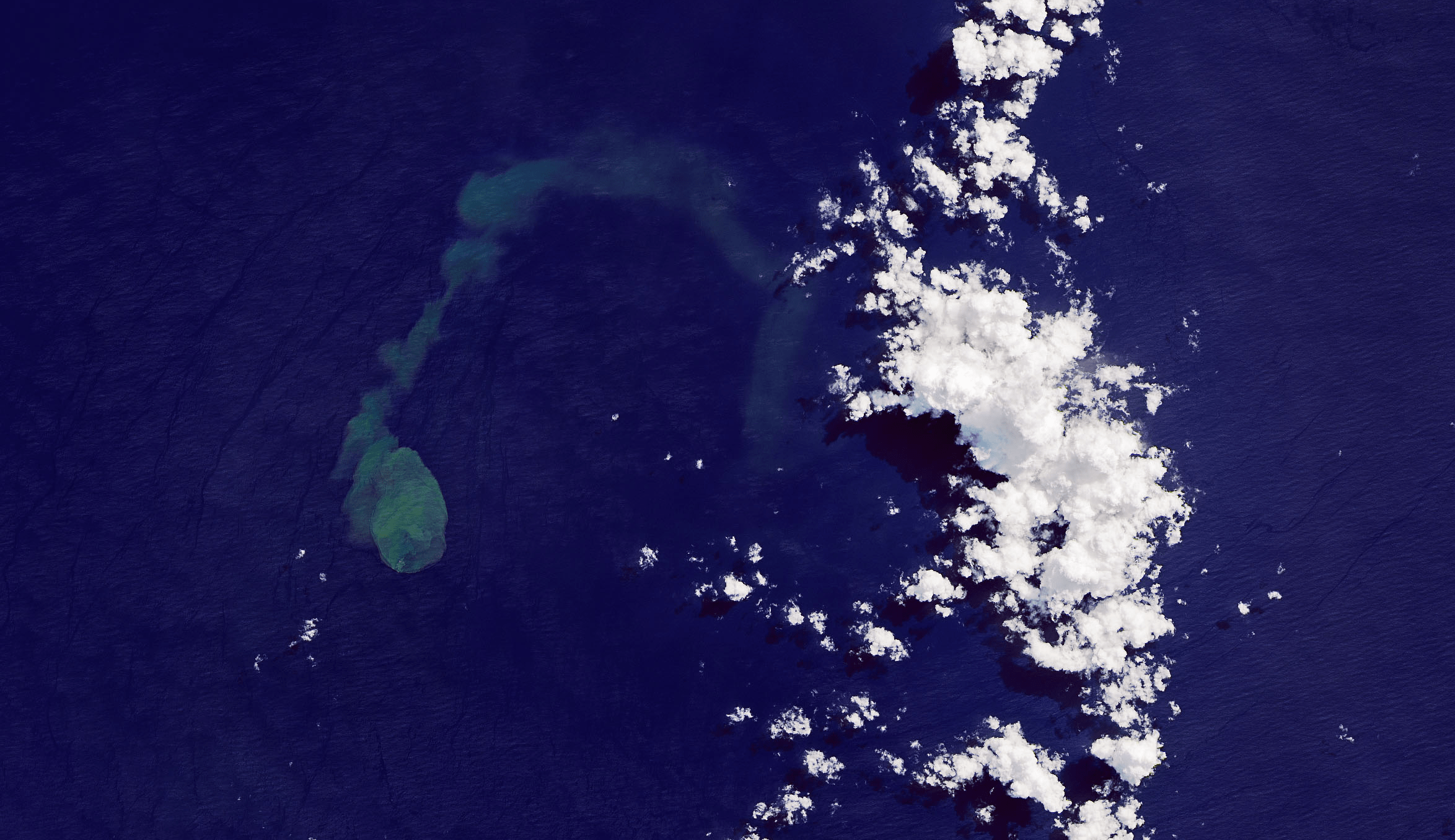 The green-blue plume on the left of this satellite image is an eruption from Kavachi, an underwater volcano.