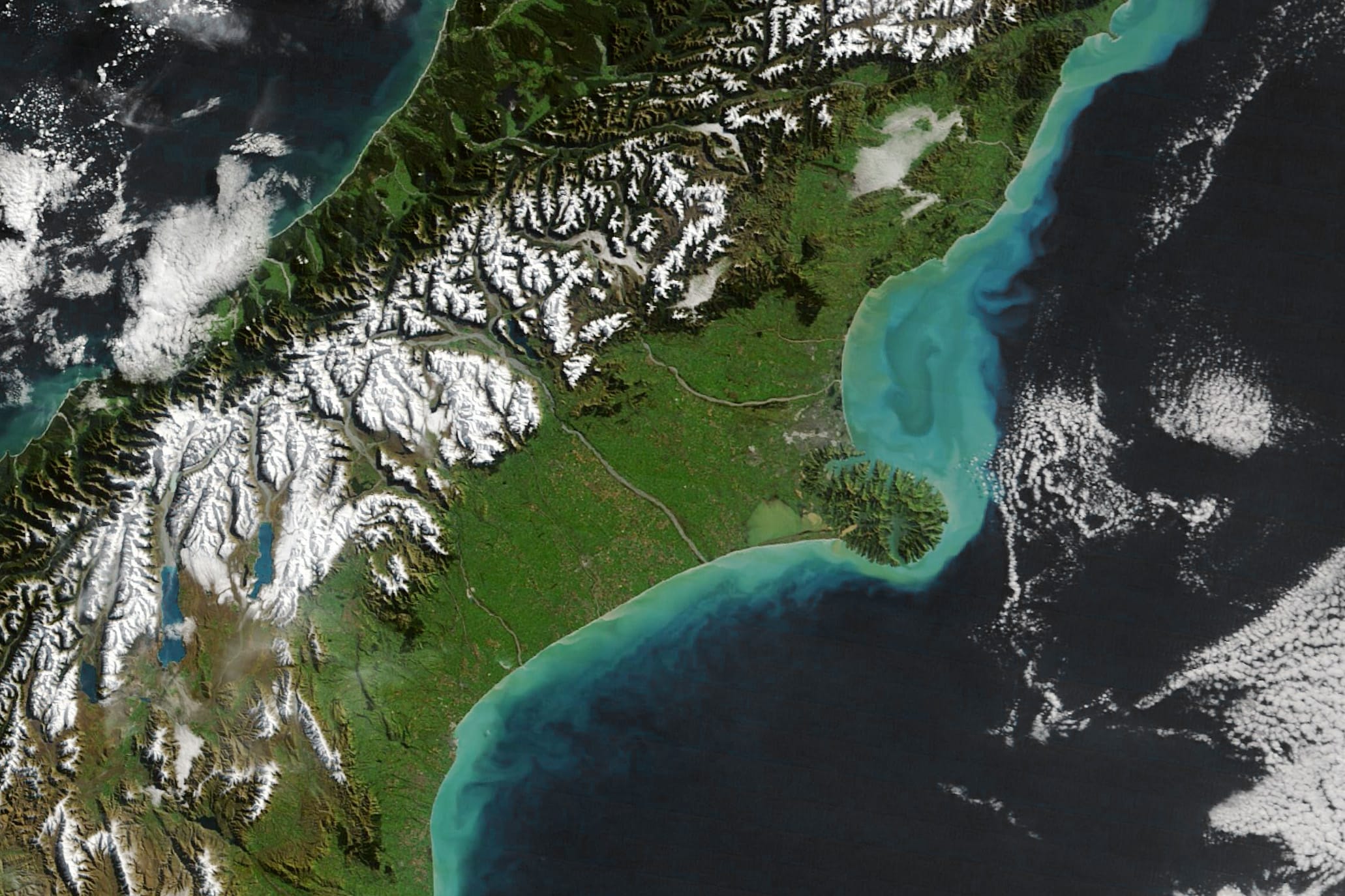 Sediment stirred up by storms lightens waters off the coast of Aotearoa New Zealand.