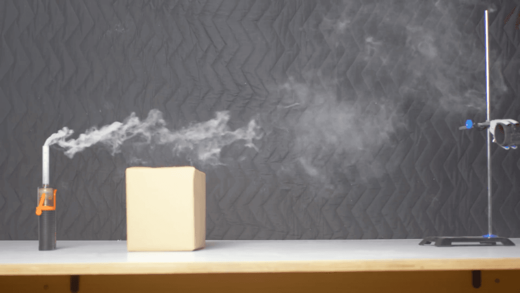 This countertop demo shows how a buoyant plume can be pulled downward in the wake of a nearby building. This countertop demo shows how a buoyant plume can be pulled downward in the wake of a nearby building.