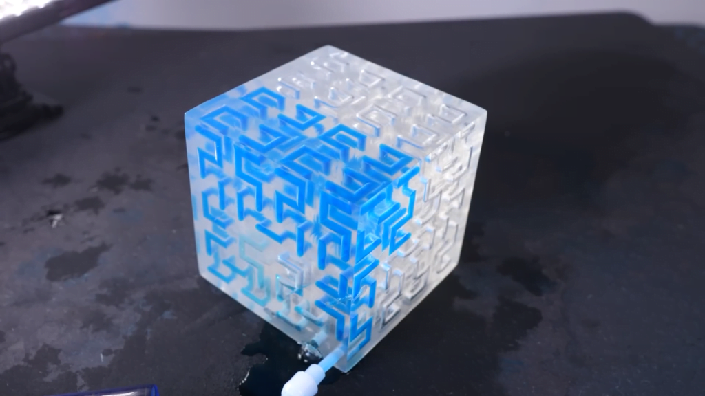 A 3D-version of a Hilbert curve being filled with dyed water. A 3D-version of a Hilbert curve being filled with dyed water.
