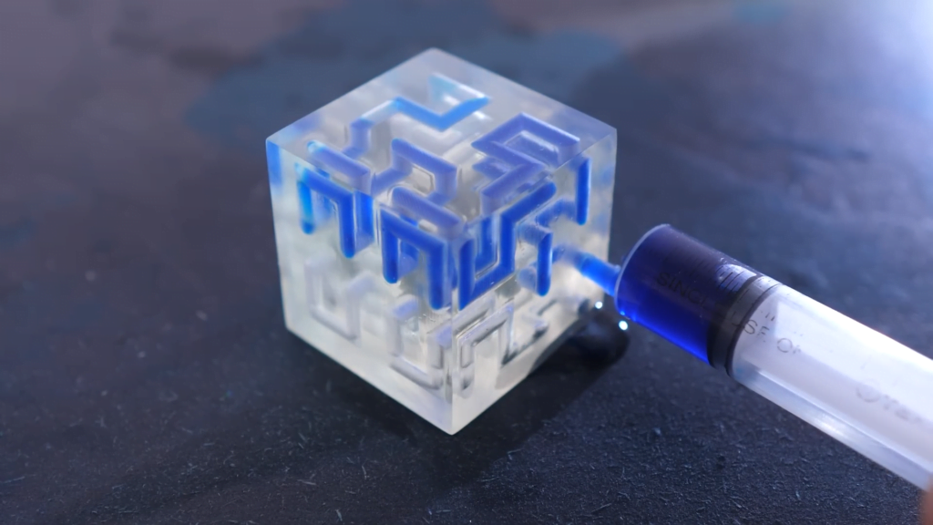 A smaller 3D-version of a Hilbert curve being filled with dyed water. A smaller 3D-version of a Hilbert curve being filled with dyed water.