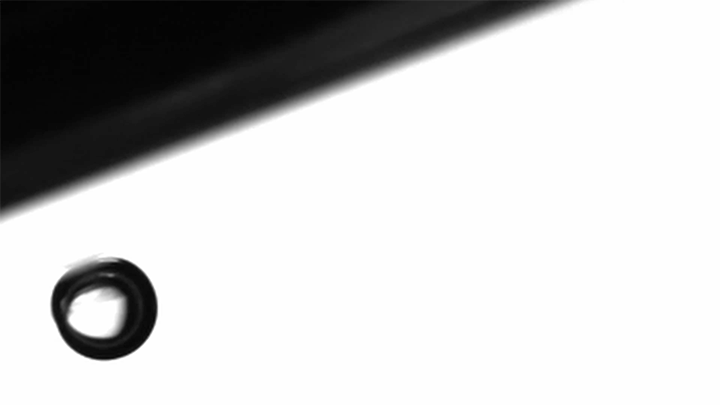 Stop-and-go. A bubble slides along an inclined surface in a pronounced stop-and-go motion when vibrated near its frequency for translational resonance.