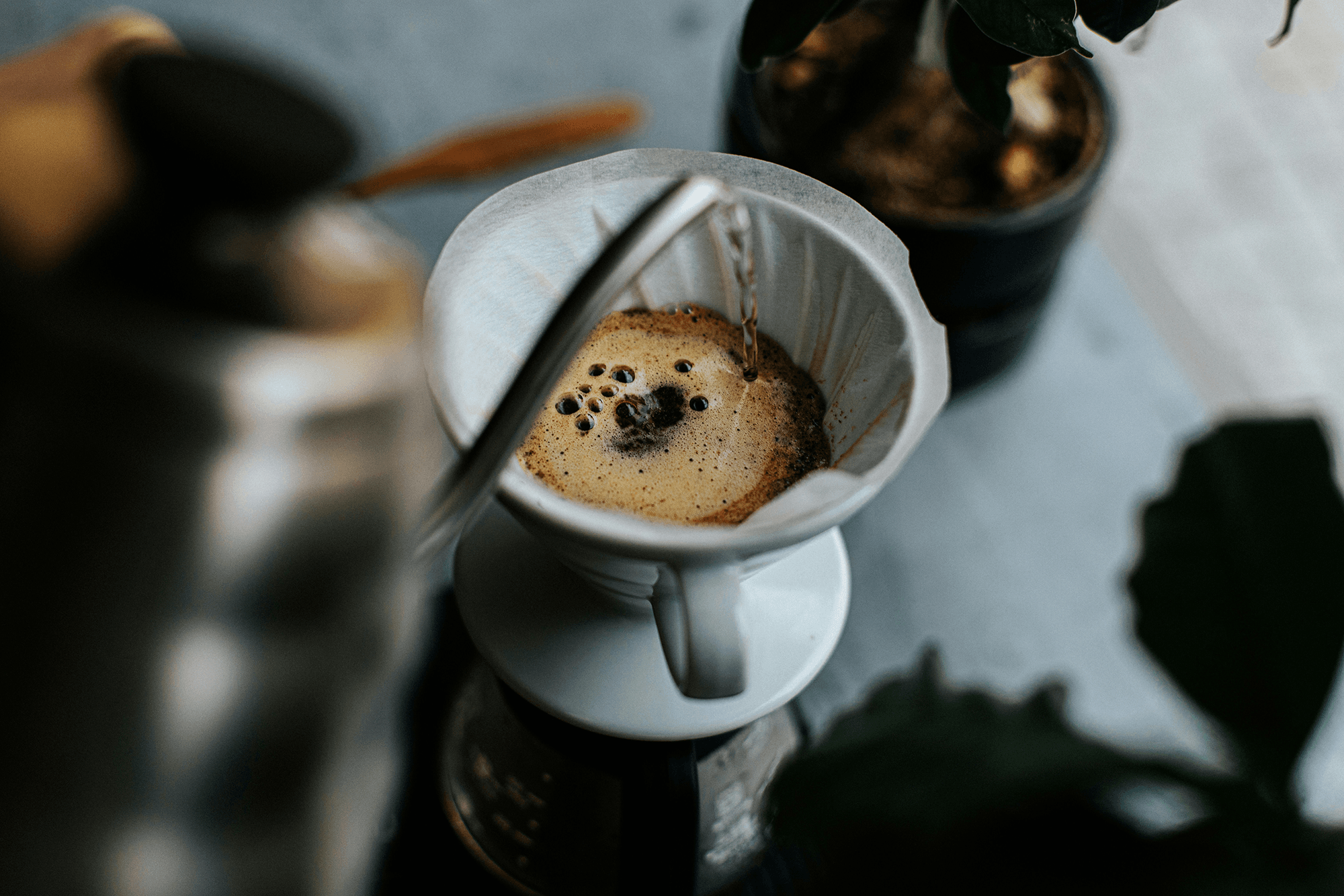 Image of a kettle pouring water into a pour-over coffee filter.