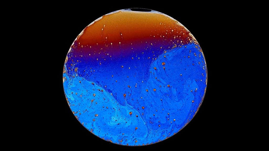 A slowly draining soap film, illuminated to show its interference colors. A slowly draining soap film, illuminated to show its interference colors.