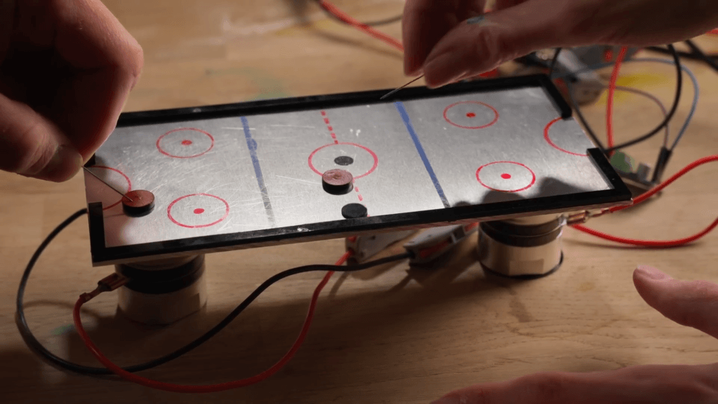 An airless "air hockey" game driven by ultrasonic levitation.