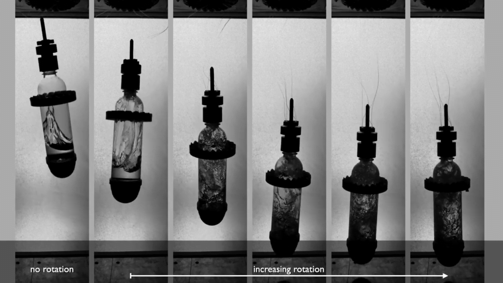 Spinning the bottle pushes water up the walls and, when the bottle impacts, that water forms a messy jet that eats up momentum that would otherwise go into a rebound. Spinning the bottle pushes water up the walls and, when the bottle impacts, that water forms a messy jet that eats up momentum that would otherwise go into a rebound.